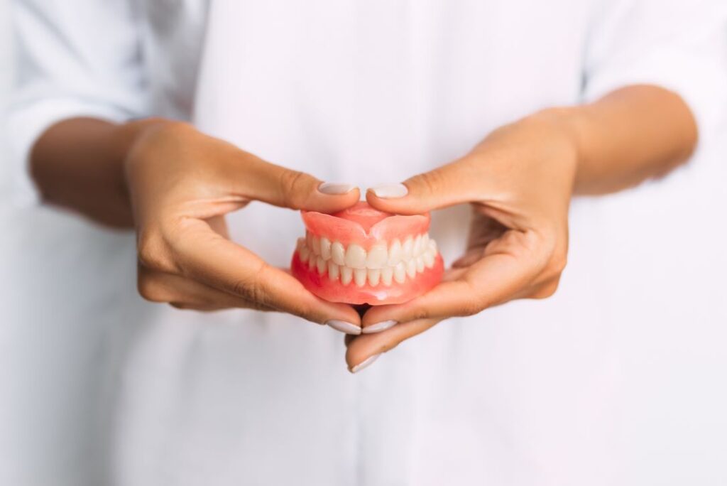 Dentist holding a pair of dentures